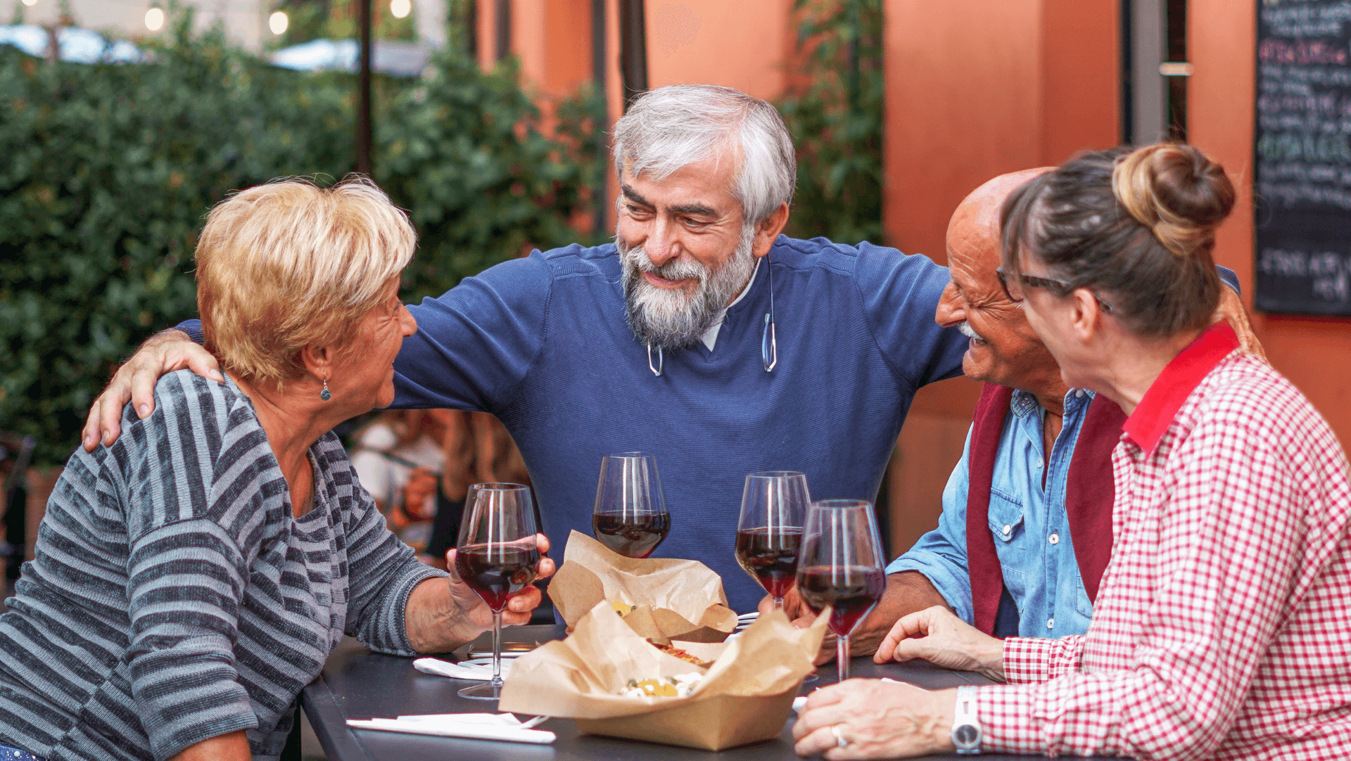 A group of friends enjoy some food, wine and laughs together