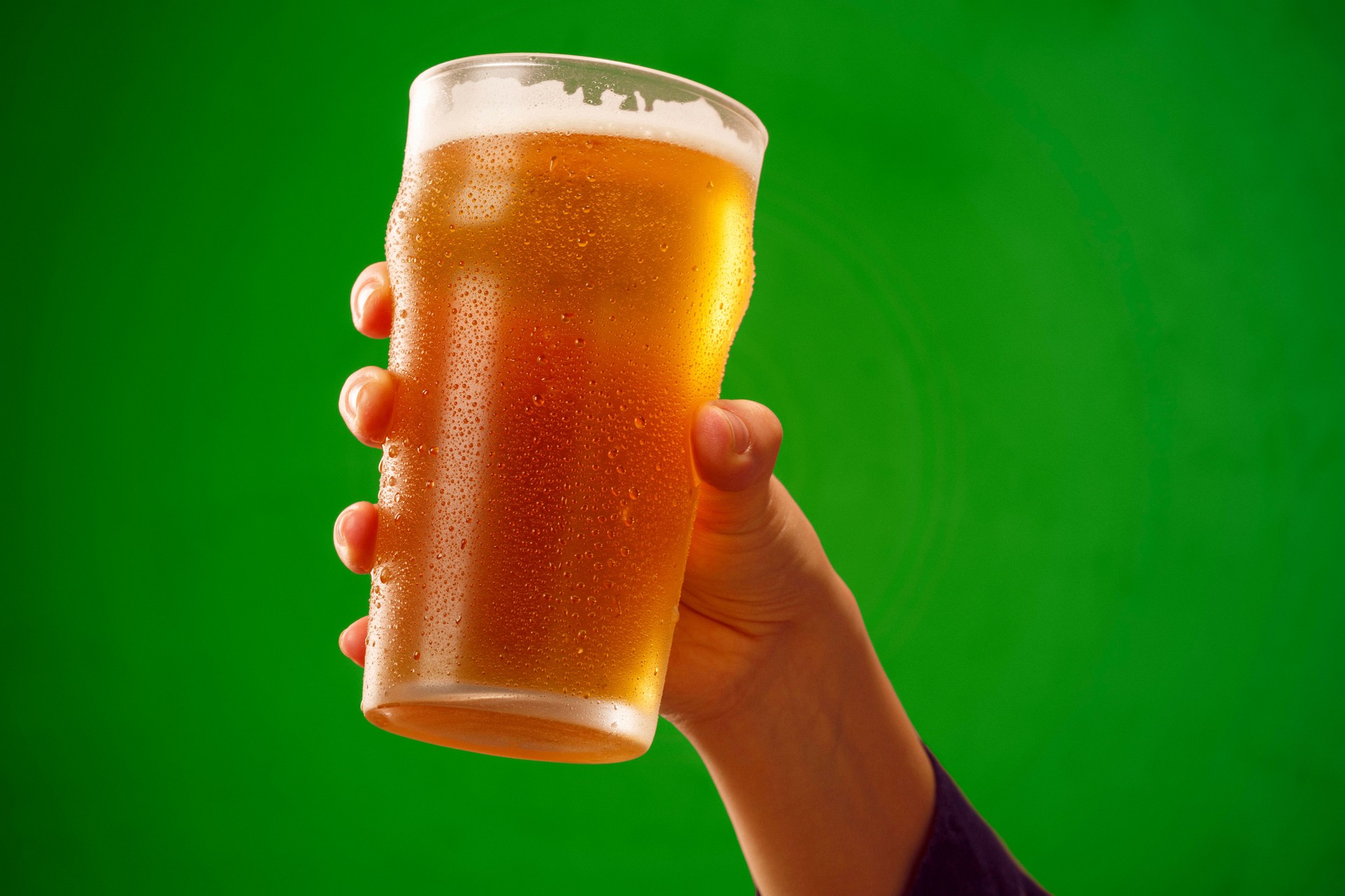 Cheers   Ice cold beer    Hand with beer glass making toast