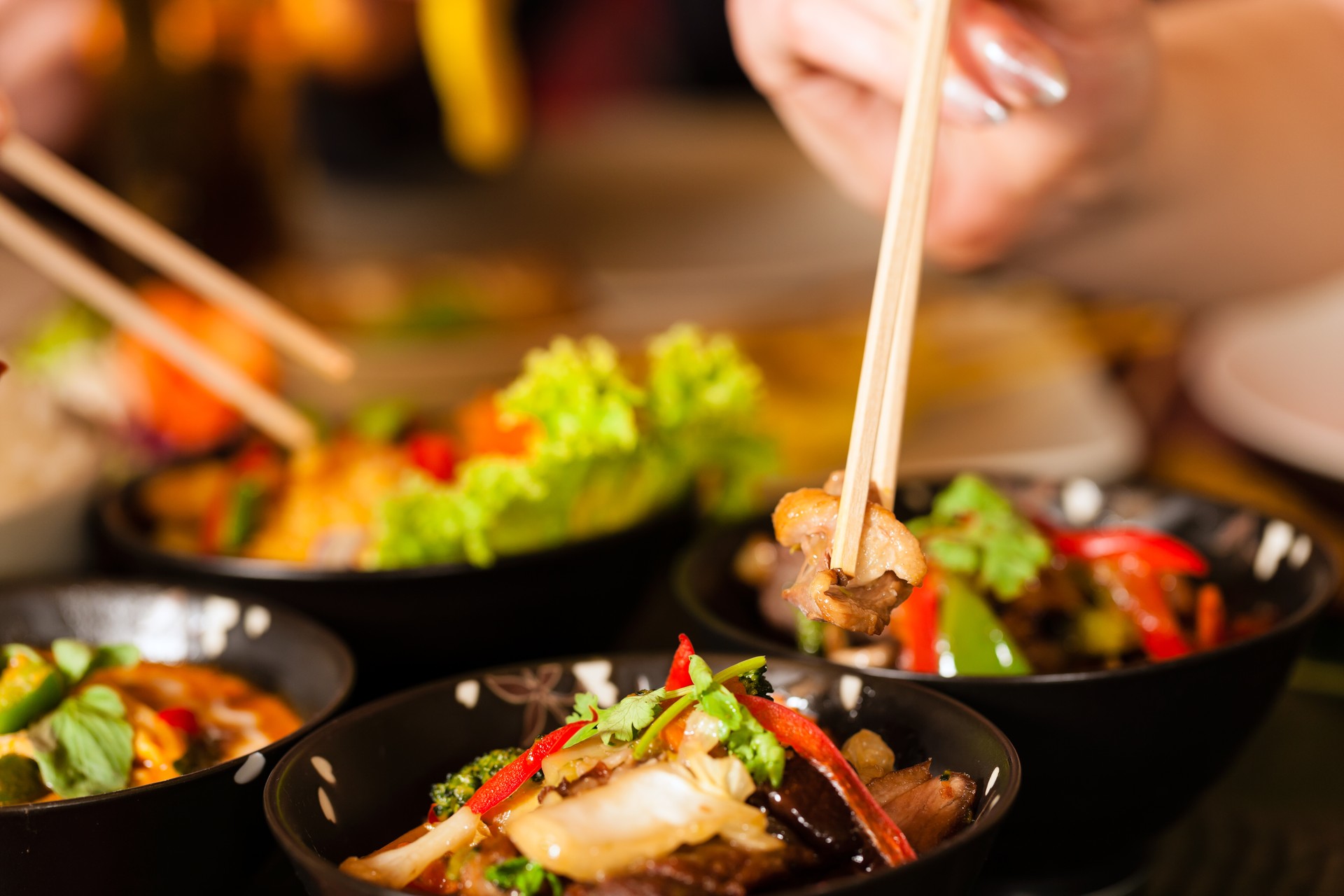 Two young people eating in a Thai restaurant 