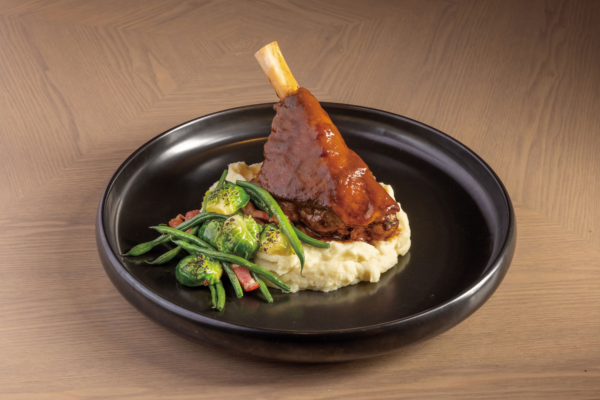 Lamb Shank with mashed potato and salad served in dish isolated on table top view of thai food