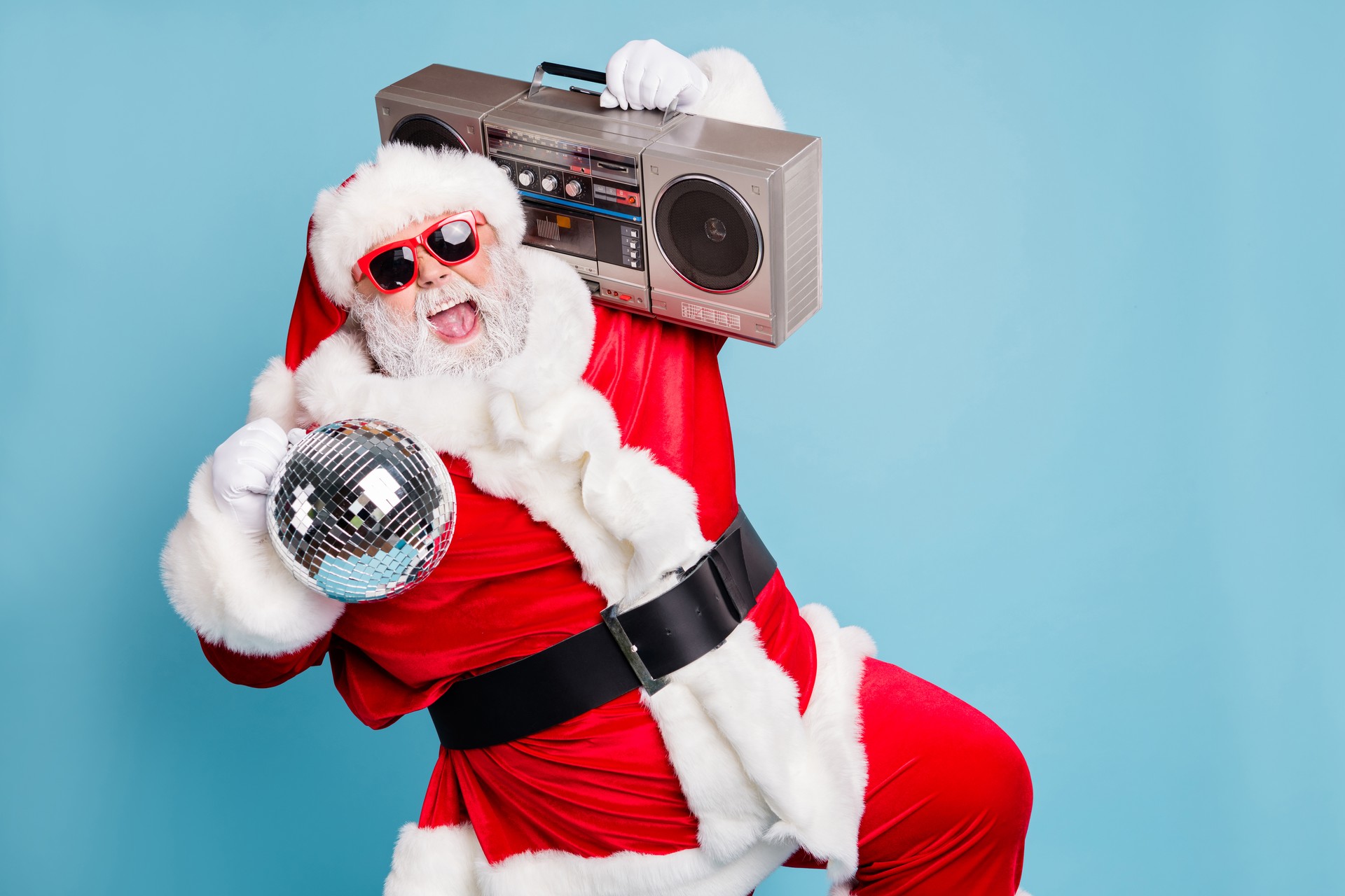 Portrait of his he nice cool fat cheerful cheery glad excited ecstatic overjoyed crazy carefree bearded Santa carrying tape player dancing having fun isolated on blue turquoise pastel color background