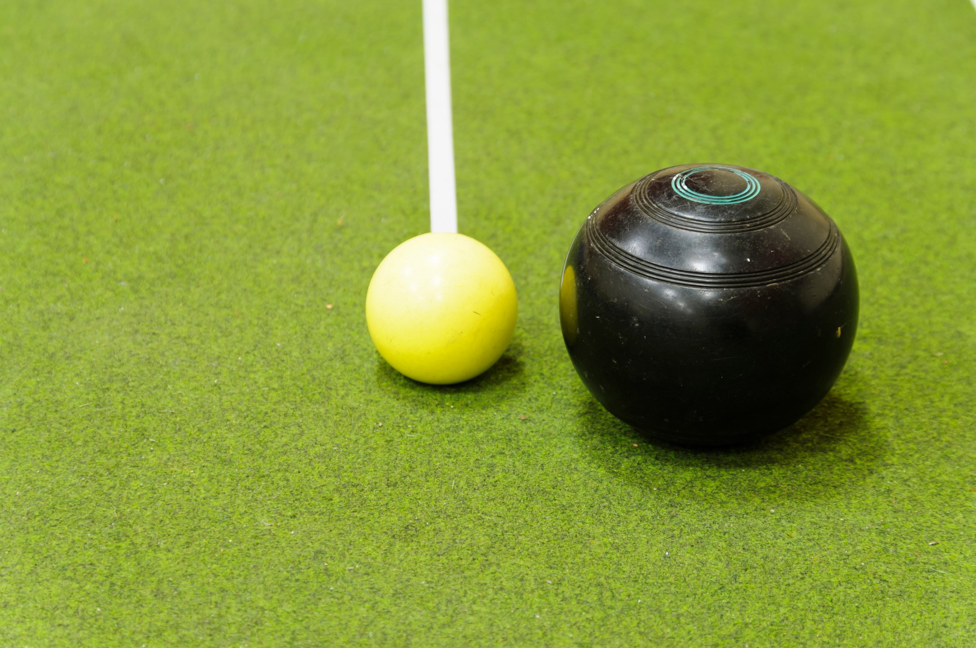 Bowl and jack on an indoor bowls carpet