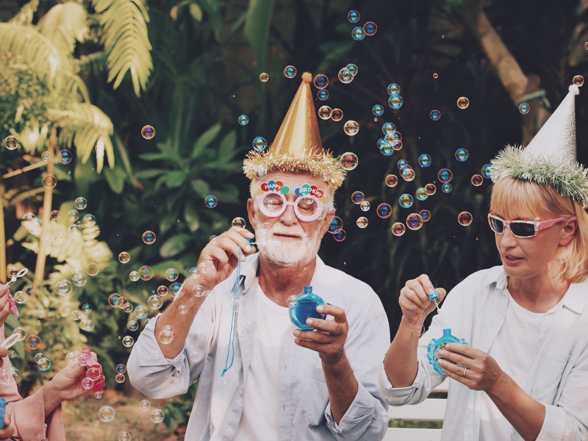 Couple enjoy a birthday party with bubble blowers